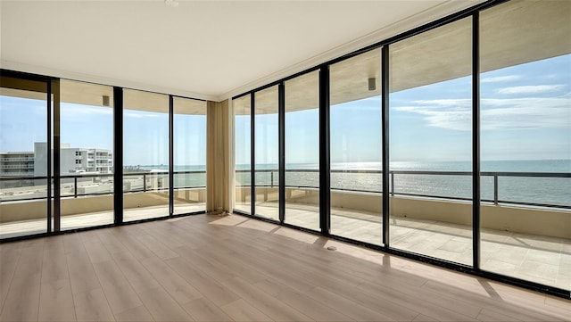 unfurnished sunroom with a water view