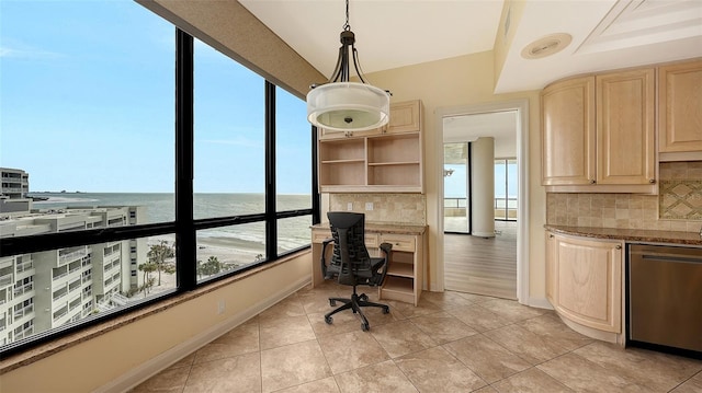 tiled office space featuring a water view