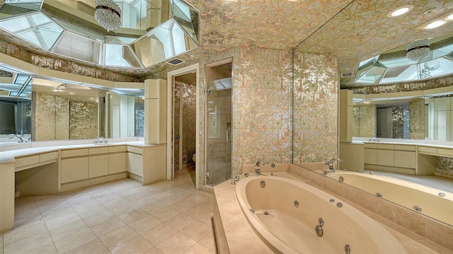 bathroom with vanity, independent shower and bath, and tile patterned flooring