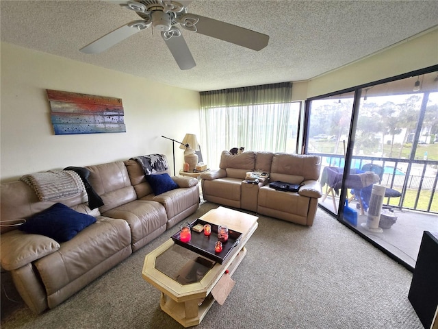 carpeted living room with a textured ceiling and ceiling fan