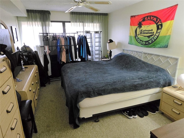 bedroom featuring ceiling fan and carpet