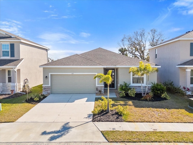 view of front of home featuring a garage and a front lawn