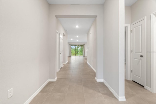 hall featuring light tile patterned floors