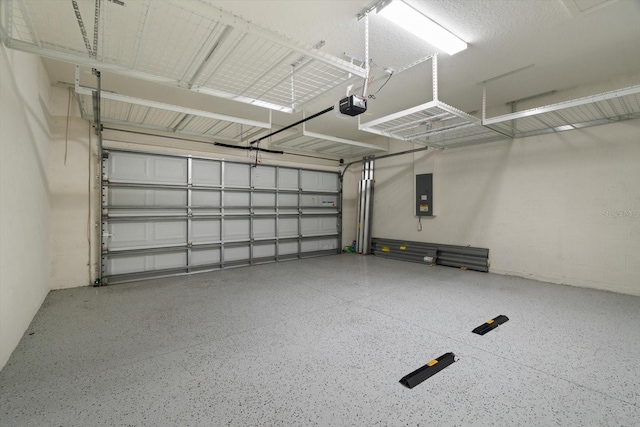 garage with a garage door opener and electric panel