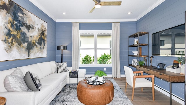 living room with hardwood / wood-style flooring, crown molding, and ceiling fan