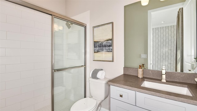 bathroom featuring an enclosed shower, vanity, and toilet