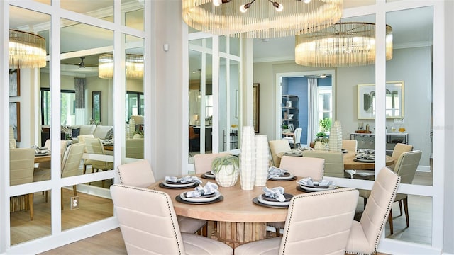 dining room with wood-type flooring, an inviting chandelier, and ornamental molding