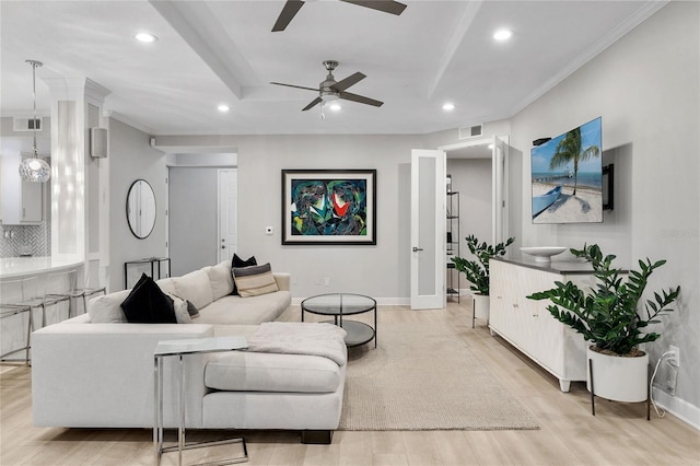 living room featuring light wood-type flooring, ceiling fan, and crown molding