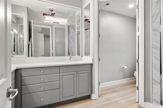 bathroom with hardwood / wood-style floors, toilet, and vanity