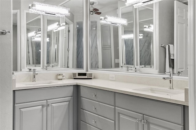 bathroom with ceiling fan and vanity