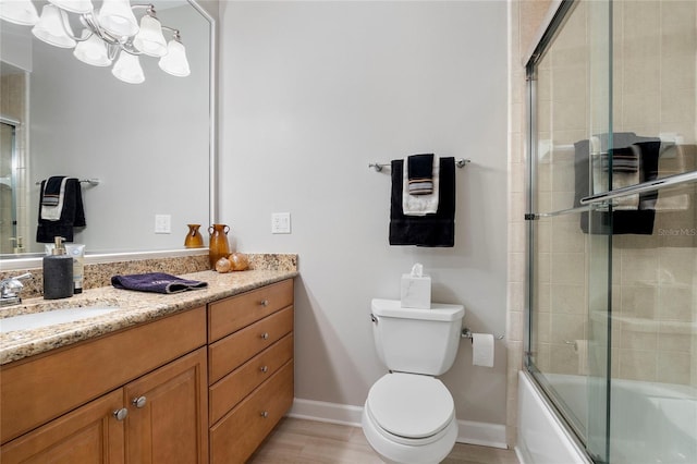 full bathroom featuring bath / shower combo with glass door, toilet, and vanity