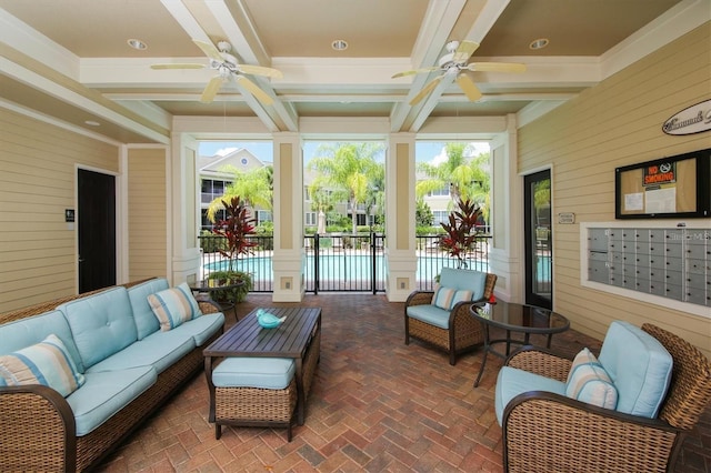 sunroom featuring coffered ceiling, beamed ceiling, a mail area, and ceiling fan