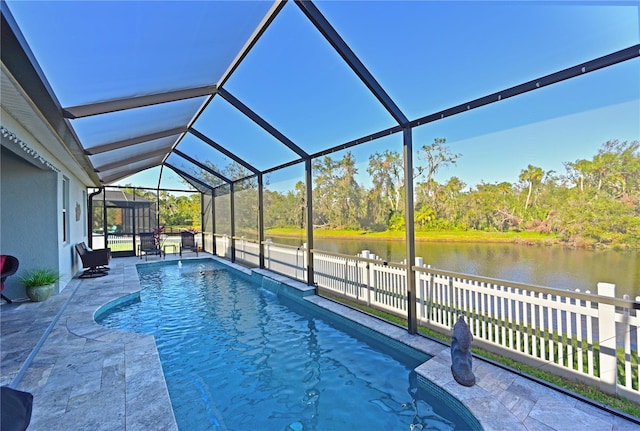 view of swimming pool featuring a water view, a patio, and a lanai