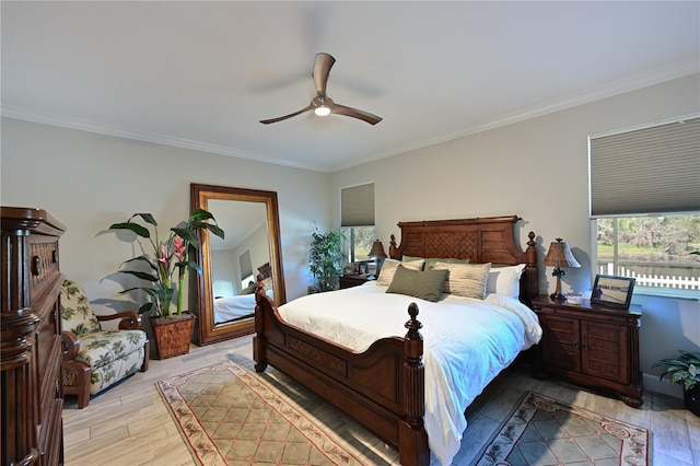 bedroom with ceiling fan, light hardwood / wood-style floors, and ornamental molding