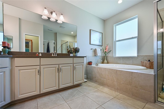 bathroom featuring vanity, independent shower and bath, and tile patterned flooring