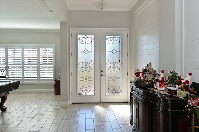 entryway featuring crown molding and french doors