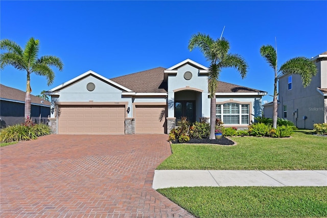 view of front of house featuring a front yard, french doors, and a garage