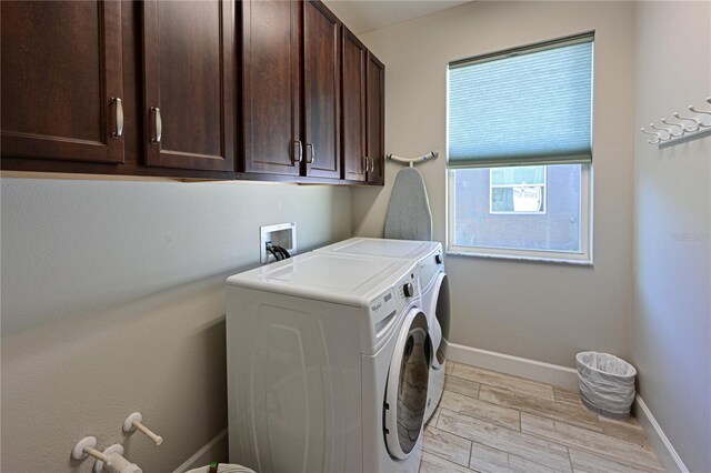 washroom featuring cabinets and independent washer and dryer