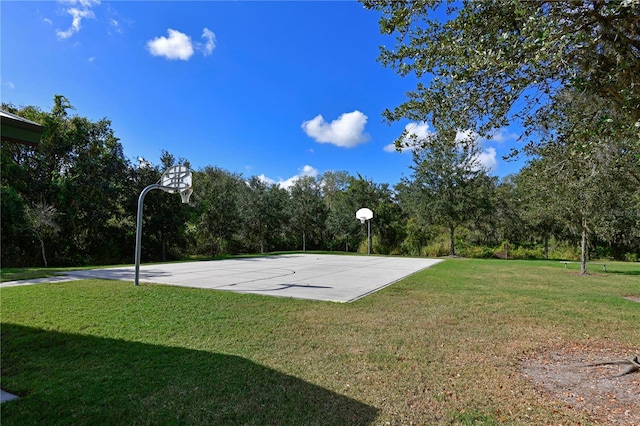 view of basketball court with a yard