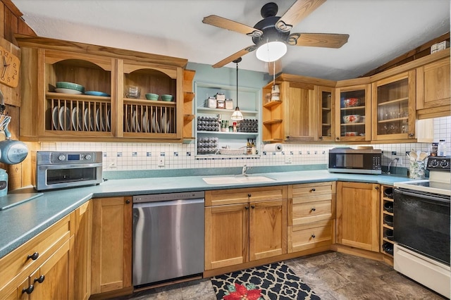 kitchen with sink, decorative light fixtures, appliances with stainless steel finishes, ceiling fan, and decorative backsplash