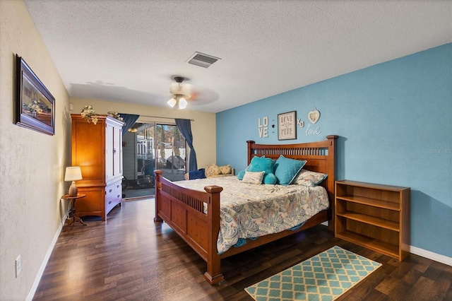 bedroom featuring ceiling fan, dark wood-type flooring, access to exterior, and a textured ceiling