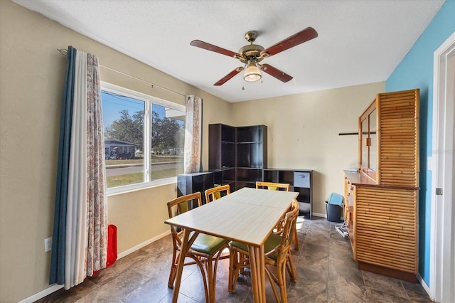 dining area featuring a textured ceiling and ceiling fan