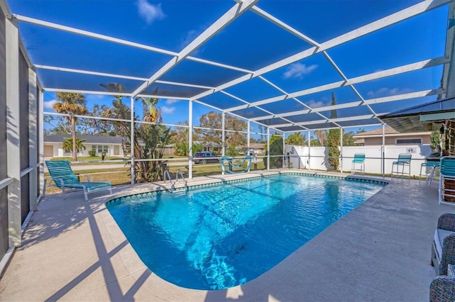 view of pool featuring a patio area and glass enclosure