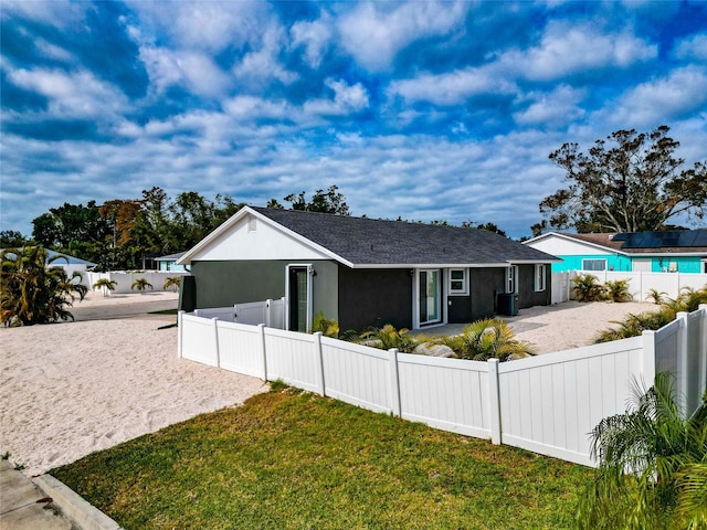 view of front of property featuring central AC and a front lawn