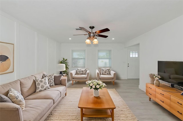 living room featuring ceiling fan and light wood-type flooring