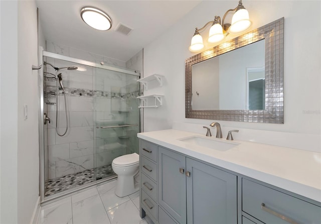 bathroom with vanity, toilet, and a shower with shower door