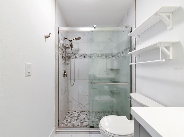 bathroom with vanity, a shower with shower door, and toilet