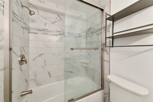 bathroom with shower / bath combination with glass door and toilet