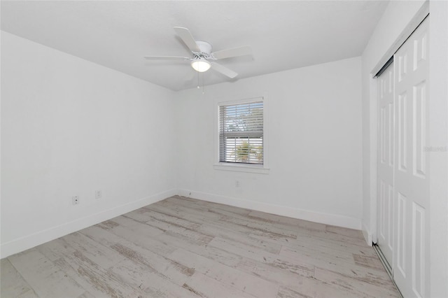 unfurnished bedroom featuring light hardwood / wood-style floors, a closet, and ceiling fan