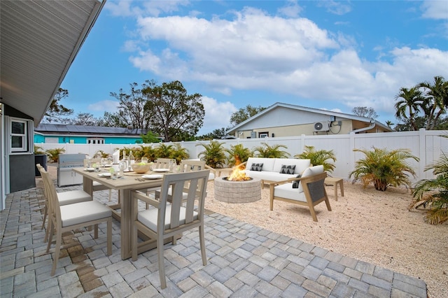 view of patio with exterior kitchen and a fire pit