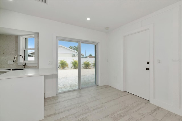 interior space with light hardwood / wood-style floors and sink