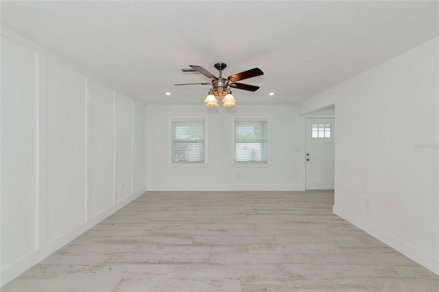 spare room with light hardwood / wood-style floors and ceiling fan