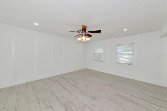 empty room featuring ceiling fan and light hardwood / wood-style floors