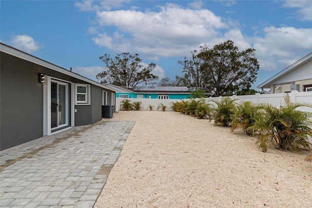 view of yard featuring a patio and central air condition unit