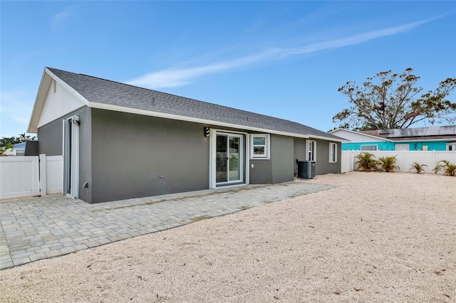 back of house with central AC unit and a patio area