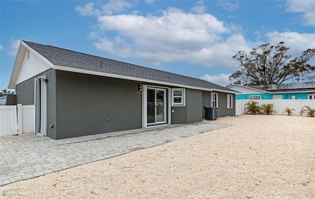 rear view of property featuring cooling unit and a patio