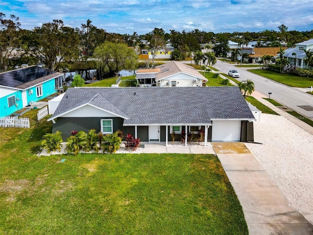 view of front of house featuring a garage and a front lawn