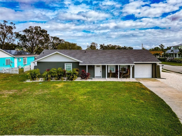 ranch-style home with a garage and a front lawn