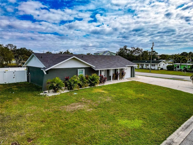 ranch-style home with a garage and a front lawn