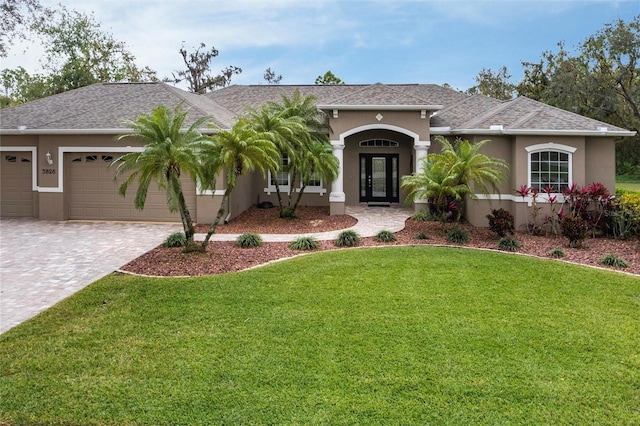 view of front of home with a front lawn and a garage