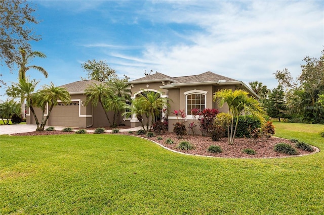 mediterranean / spanish home with a front yard and a garage