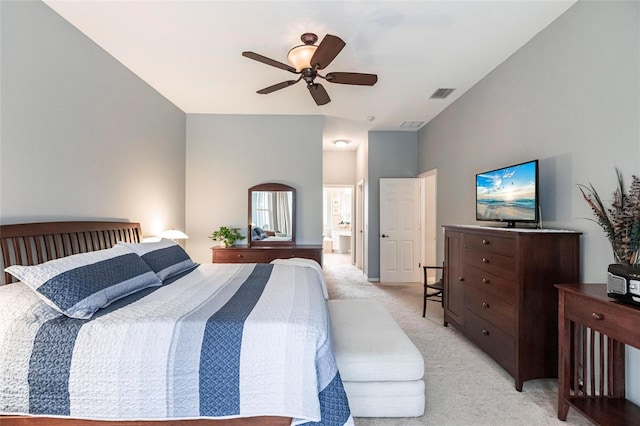 bedroom featuring ensuite bathroom, light colored carpet, and ceiling fan