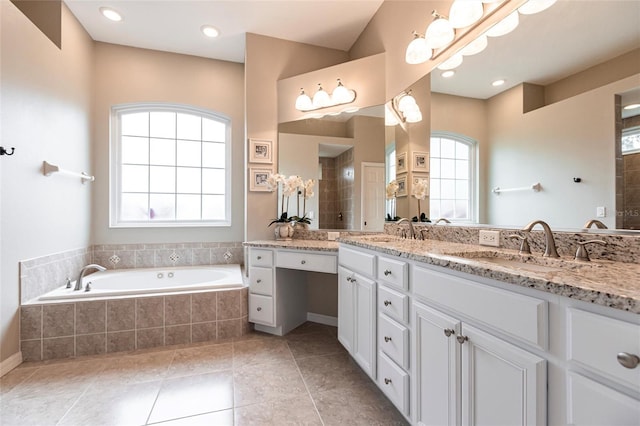 bathroom featuring tile patterned floors, separate shower and tub, and vanity