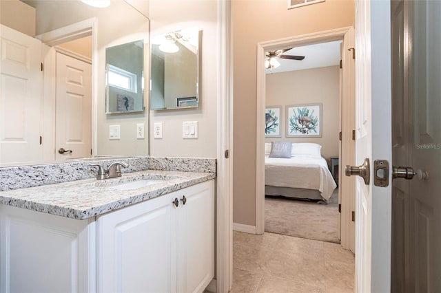 bathroom featuring ceiling fan, vanity, and tile patterned floors