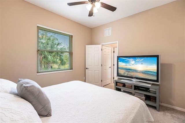 bedroom featuring light carpet and ceiling fan