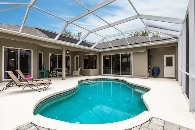 view of swimming pool with a patio area and a lanai